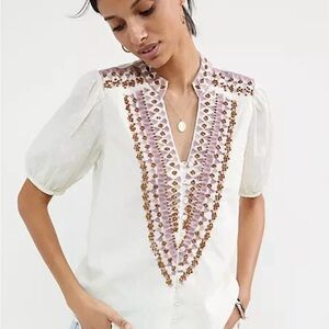 Anthropologie Cream color with embroidery and wood beads.